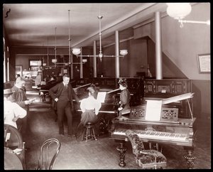 A showroom of the New England Piano Co., 1895